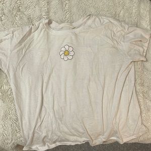 Cute summery white shirt with a adorable flower, great quality! no rips or tears